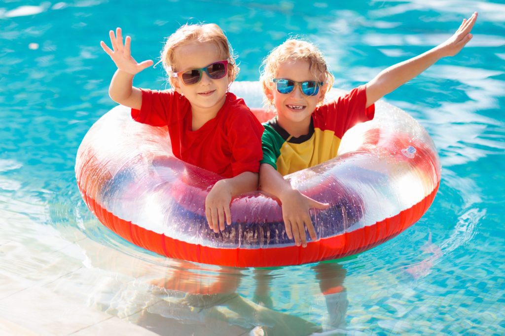 Two children enjoying Cayman Pools.